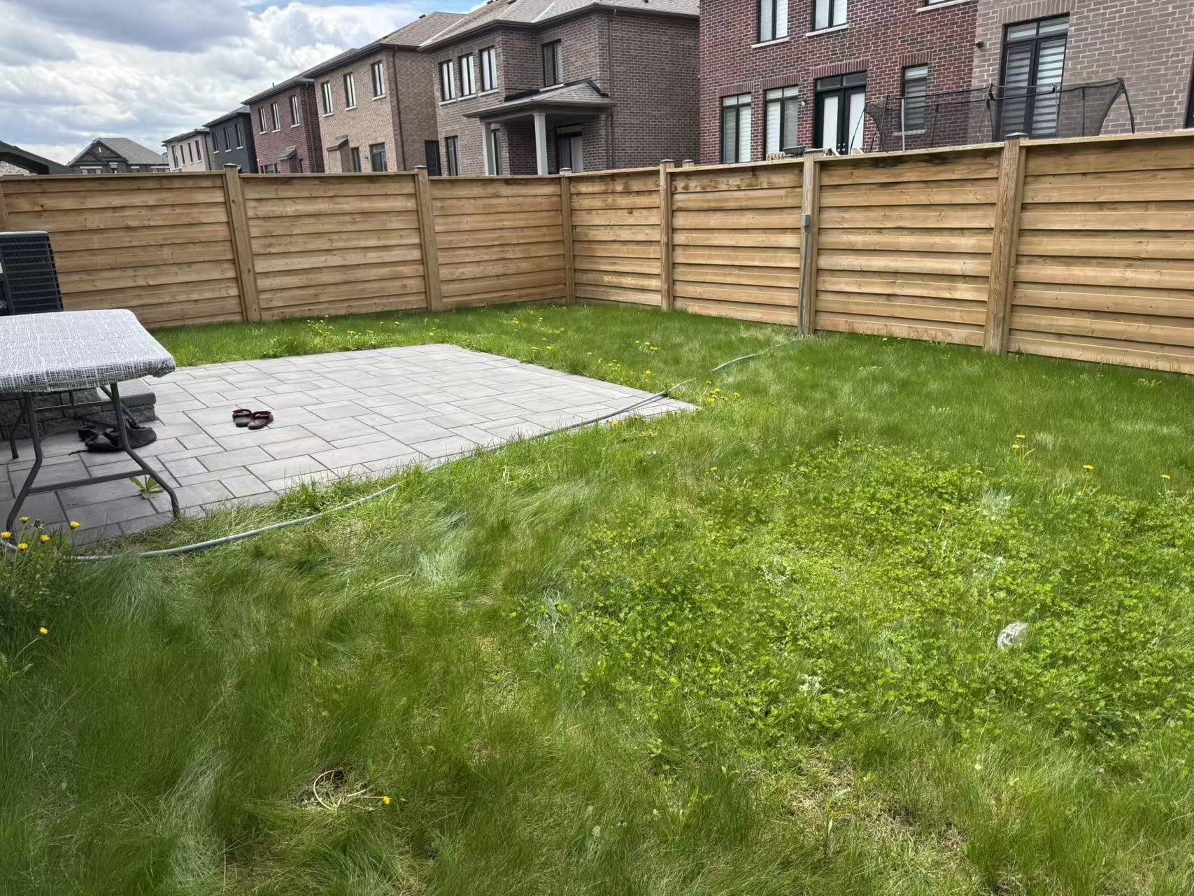 On-site measurement of an existing backyard before redesign